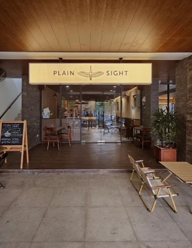 Pintu masuk Plain Sight Coffee di Emerald Core Bintaro